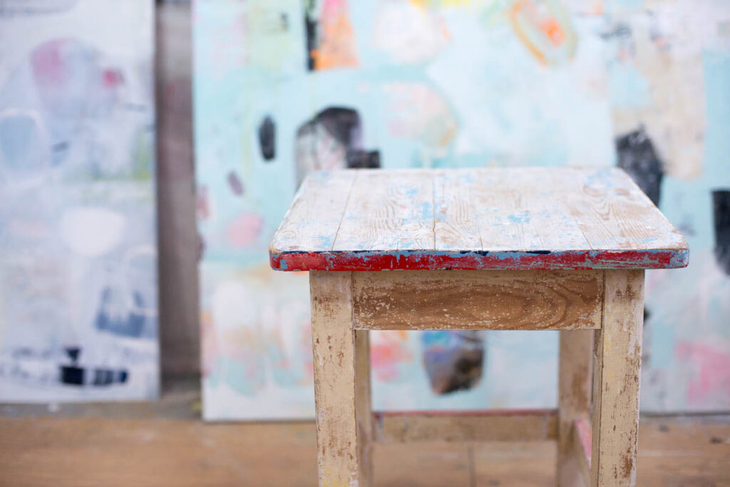A scene from the artist studio- A stool in front of a painting
